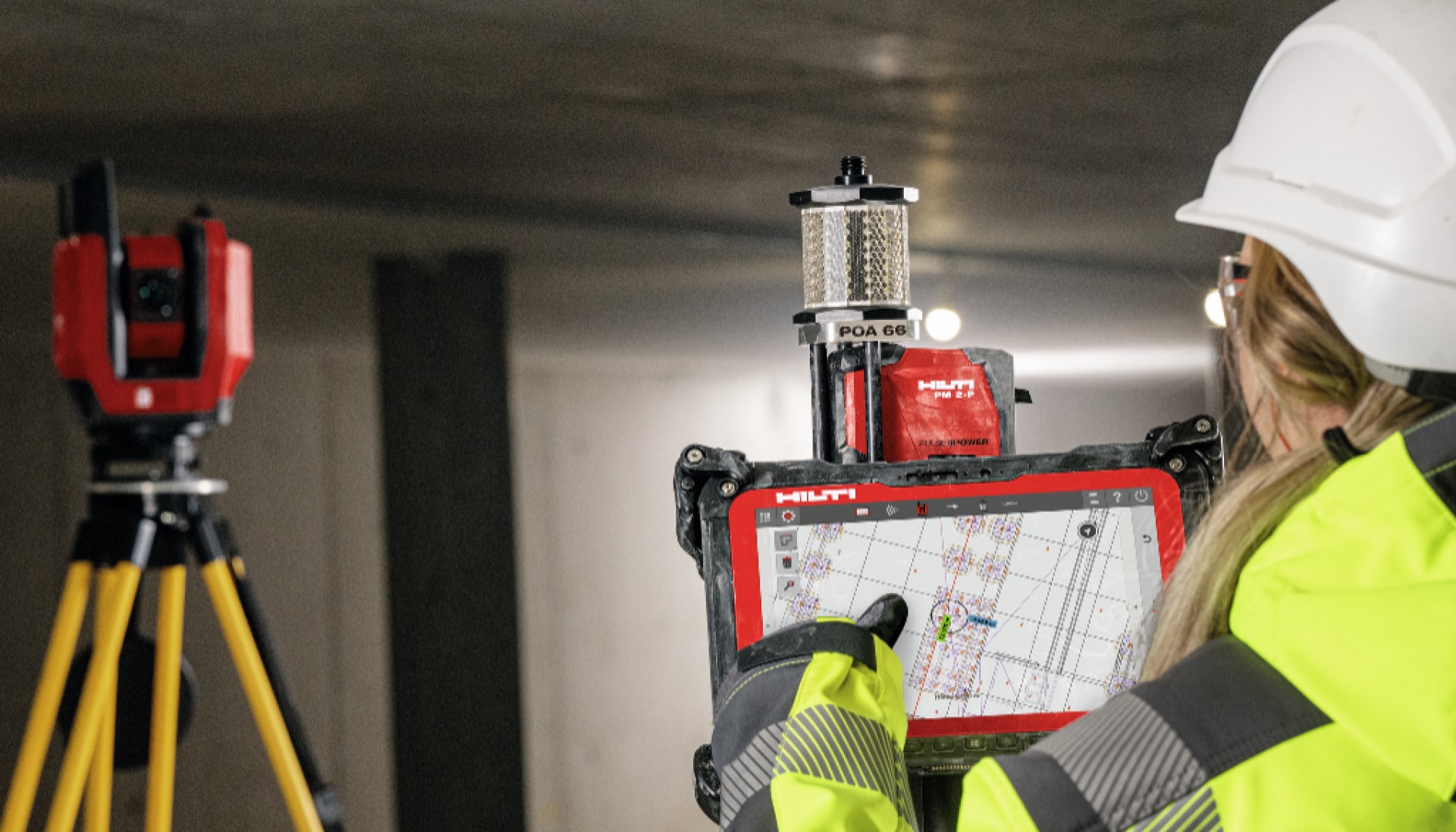 A close up of a woman using Hilti software in front of a tripod