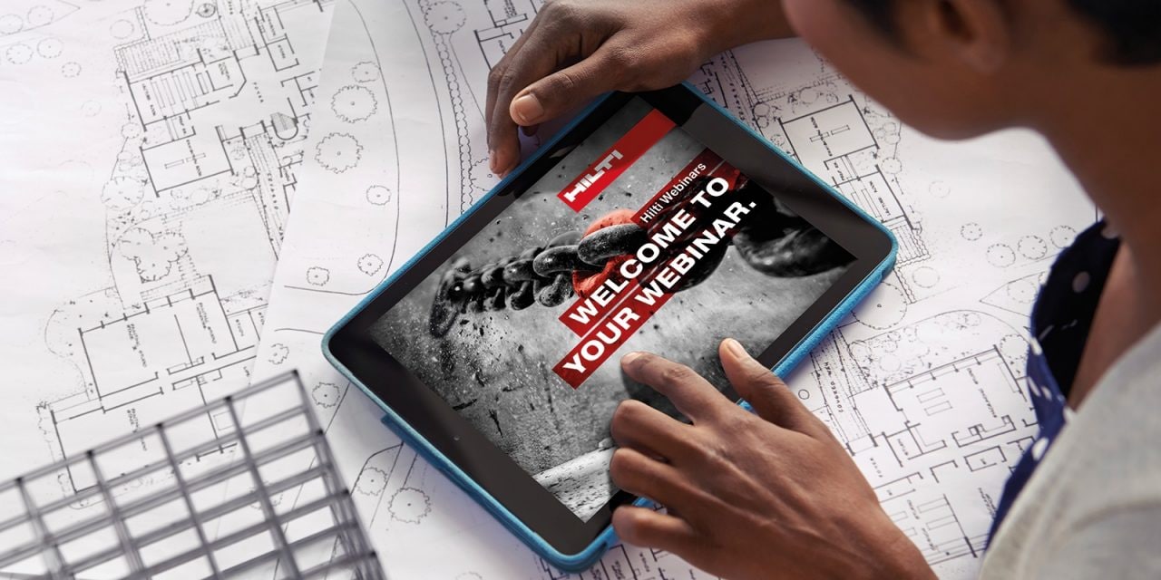 Cropped shot of a young architect using her digital tablet to work on building plans