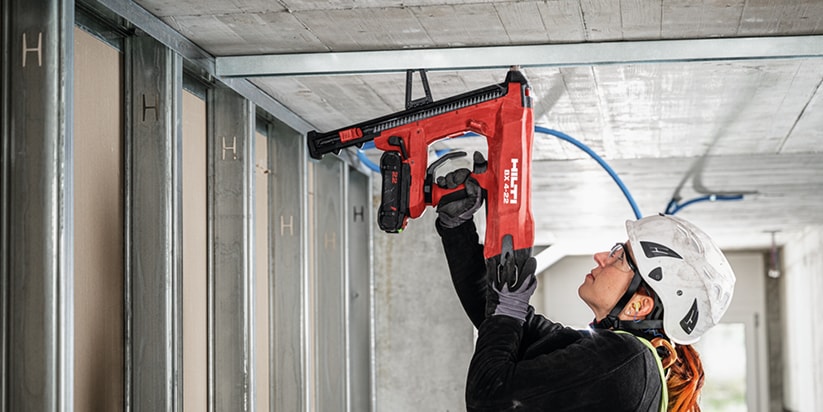 BX 3 battery-powered nailer, a virtually dust-free alternative to drilling, being used to fasten on concrete
