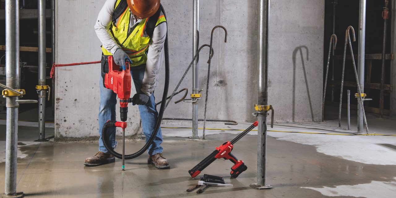 Construction worker using Hilti SafeSet installation method with VC 140-2-22 "vac-pack" vacuum and TE 60-22 cordless rotary hammer. HDE 500-22 cordless adhesive dispenser, HIT-RE 100 adhesive anchor