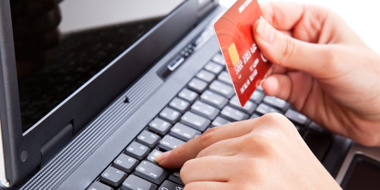 Credit card in hand for buying online