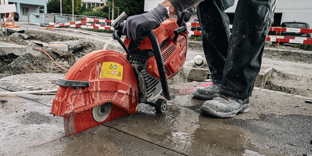 man using hilti red cut off saw