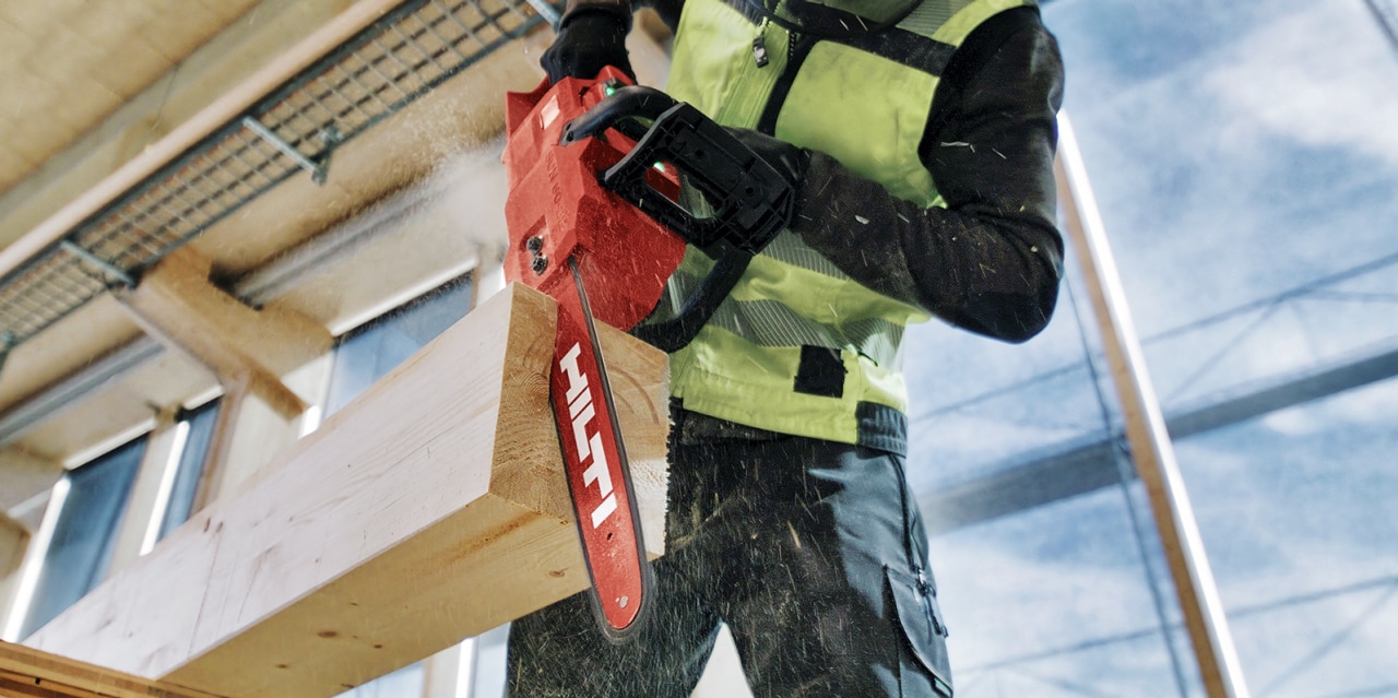 man using Hilti's cordless chainsaw
